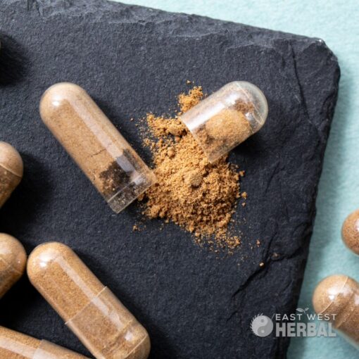 Ashwagandha Extract Capsules laying on a black slab